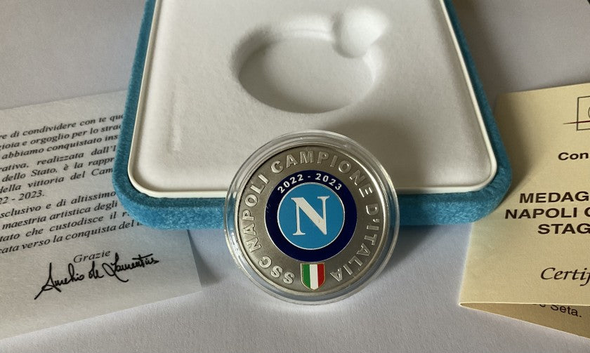 Napoli Scudetto medal held to show scale