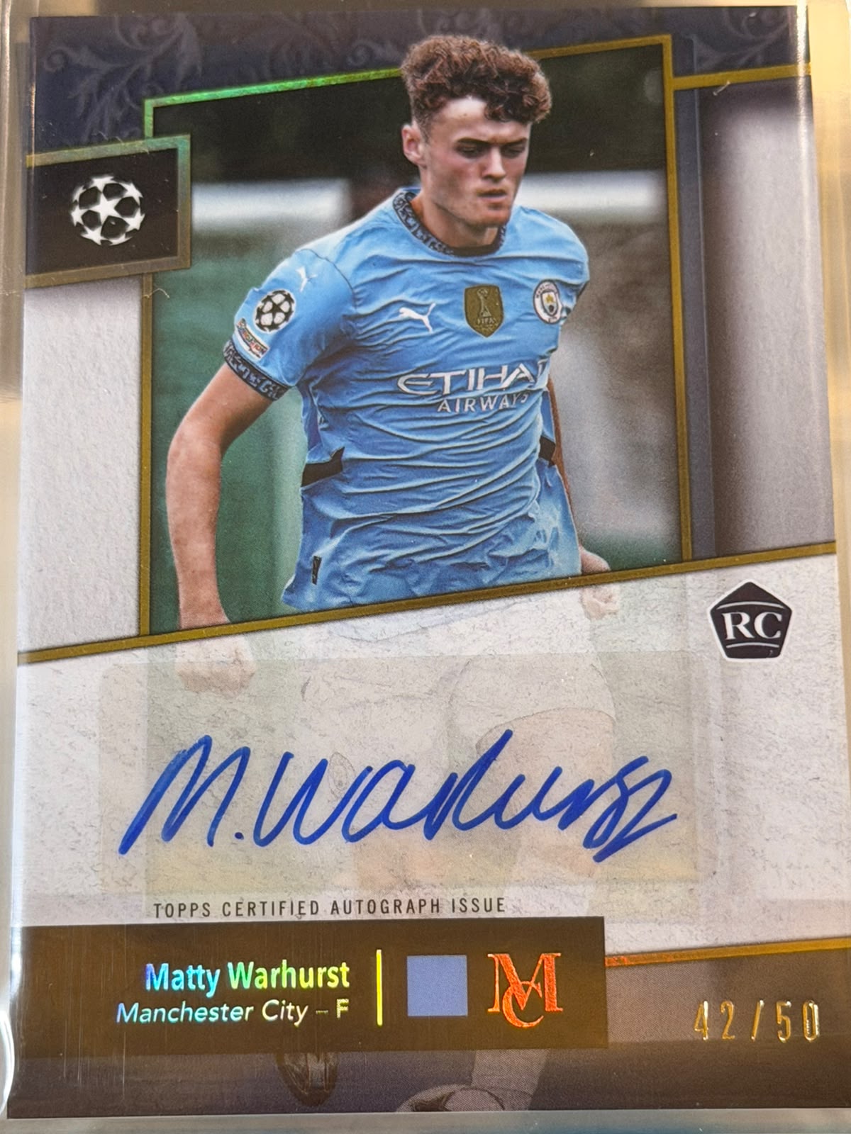 Matty Warhurst 42/50 – Archival Autograph – 2024-25 Topps Museum Collection UEFA Club… – Manchester City trading card, front