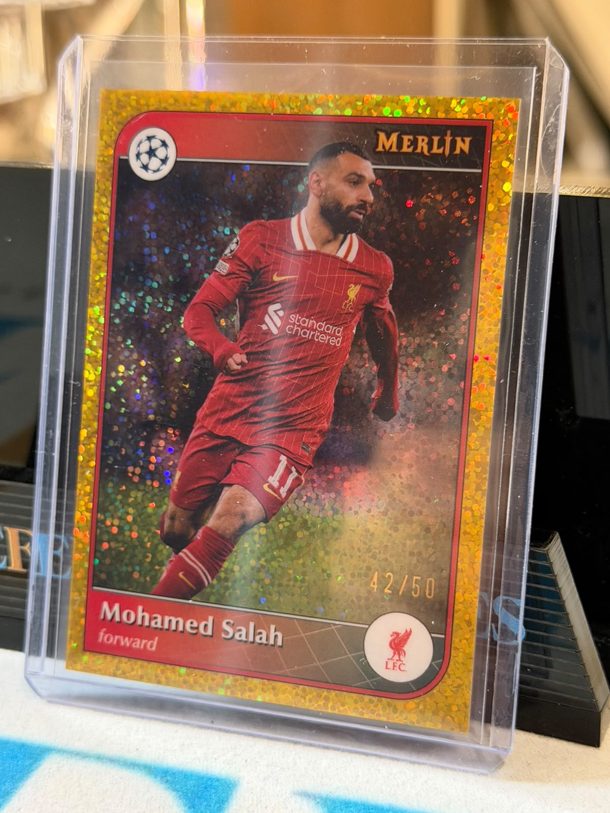 Mohamed Salah 42/50 Base #11, Gold Sparkle parallel – 2024/25 Topps Merlin, front