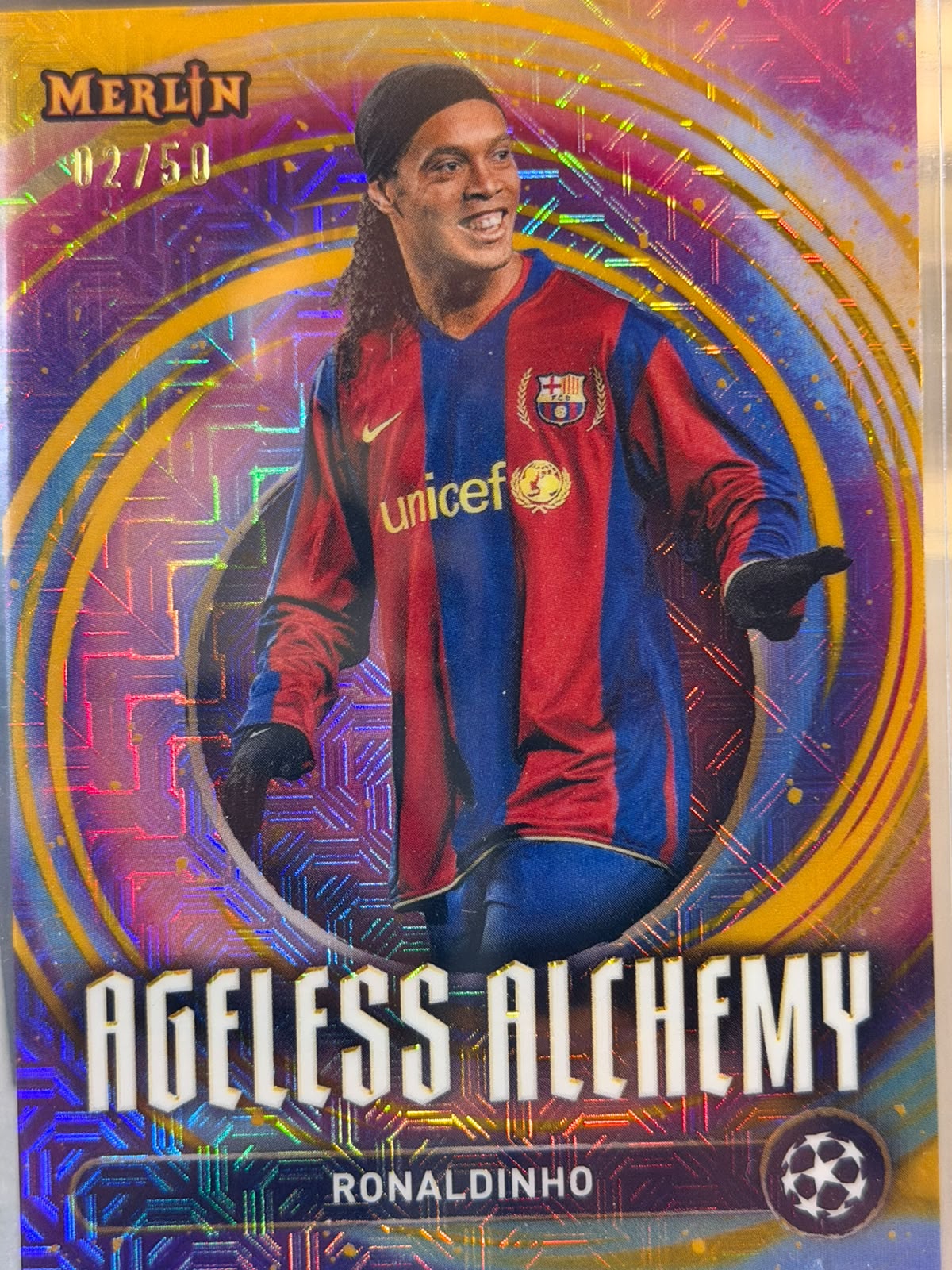 Ronaldinho 02/50 Ageless Alchemy – Topps Merlin UEFA Club Competitions 2024/25 – FC Barcelona trading card, front