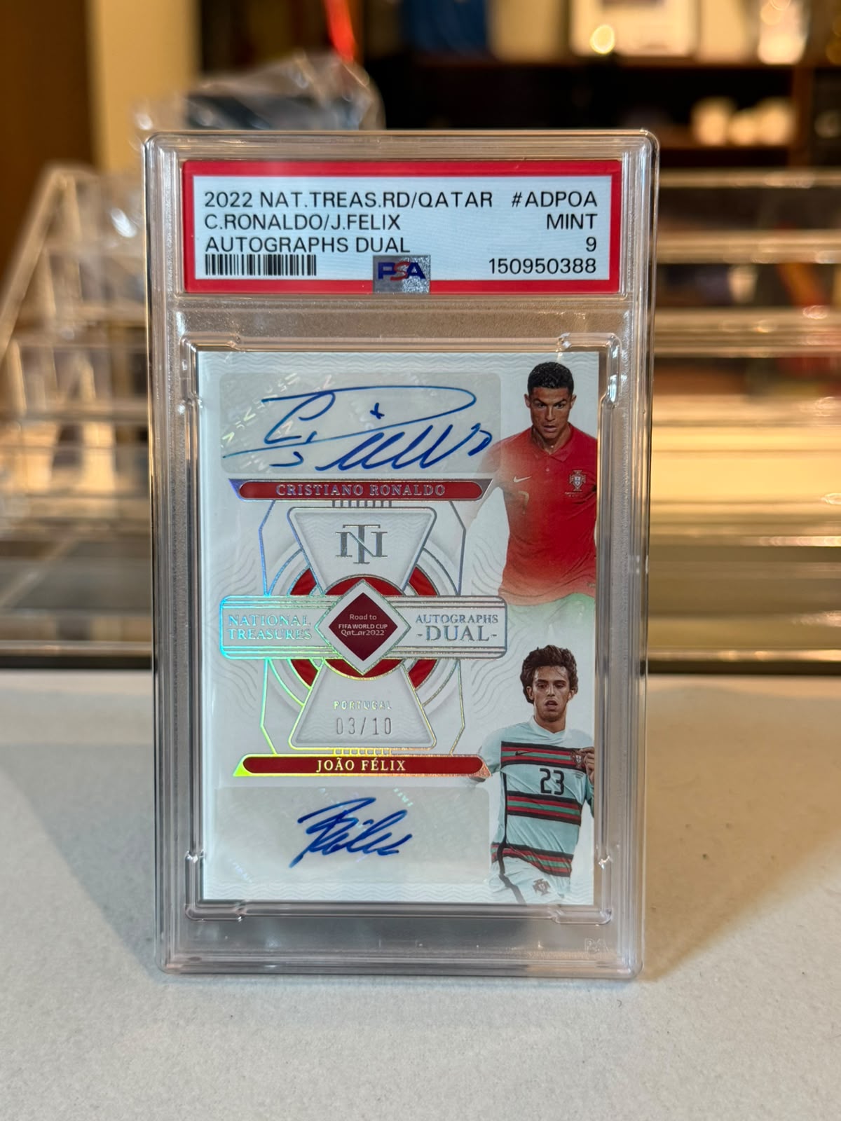 Cristiano Ronaldo and Joao Felix dual autograph card, 2022 Panini National Treasures Road to FIFA World Cup Qatar 2022, PSA 9 Mint graded slab, front view showing on-card blue ink autographs and 03/10 serial