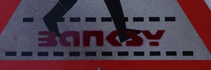 Edge view of "Walking", spray paint on plastic panel, attributed to Banksy