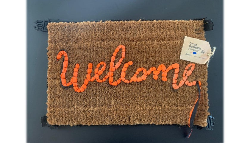 Underside view of Banksy's "Welcome Mat"