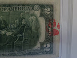 Close-up of Andy Warhol's signature on the two dollar bill