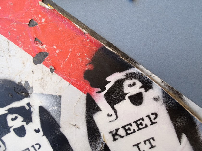 Surface condition detail on the Banksy-attributed "Keep It Real" sign