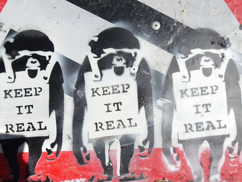Close-up of the printed signature on "Keep It Real", attributed to Banksy